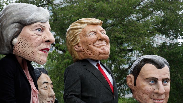 Members of OXFAM dressed as the G7 leaders pose for pictures outside the Quebec provincial building ahead of the G7 summit in Quebec City, Quebec, June 7, 2018