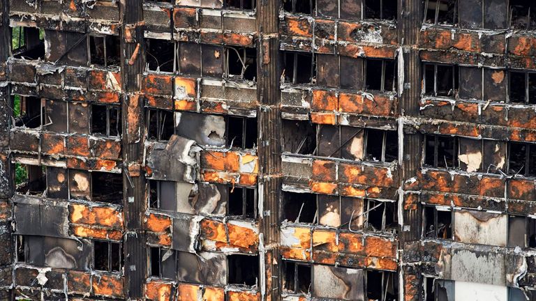 The charred remains of clading are pictured on the outer walls of the burnt out shell of the Grenfell Tower block in north Kensington, west London on June 22, 2017