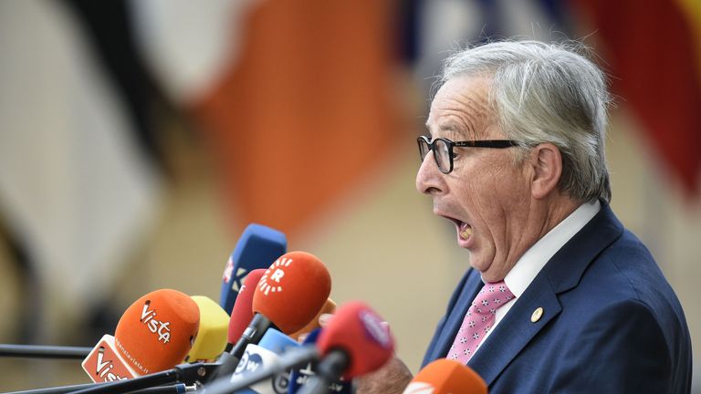 TOPSHOT - President of the European Commission Jean-Claude Juncker reacts as he speaks to journalists during an European Union leaders&#39; summit focused on migration, Brexit and eurozone reforms on June 28, 2018 at the Europa building in Brussels. - The two-day meeting in Brussels is expected to be dominated by deep divisions over migration, with German Chancellor saying the issue could decide the fate of the bloc itself. (Photo by JOHN THYS / AFP) 