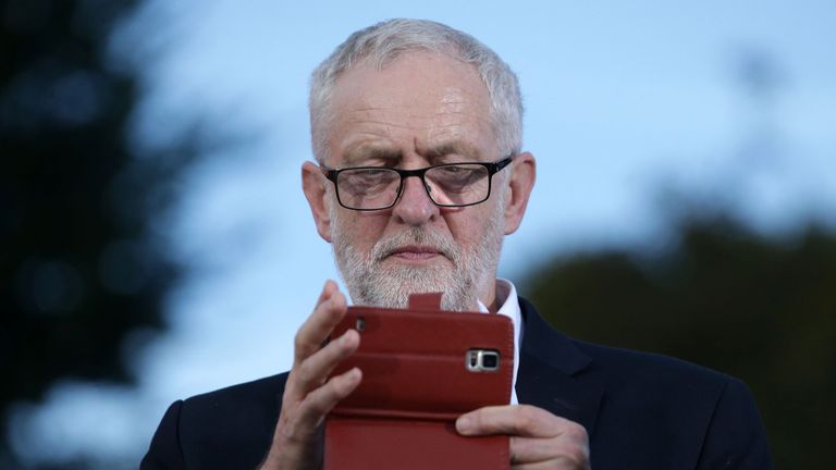 Jeremy Corbyn takes a picture with an smartphone at a rally on the eve of Labour conference in Brighton