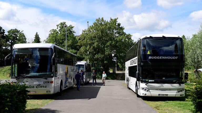 Buses with pupils on a school trip remain in the parking lot of Planckendael Zoo, after a young lioness escaped from its enclosure