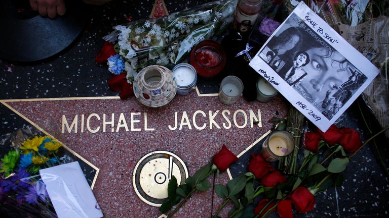 Fans pay tribute to Michael Jacson by laying flowers on his star