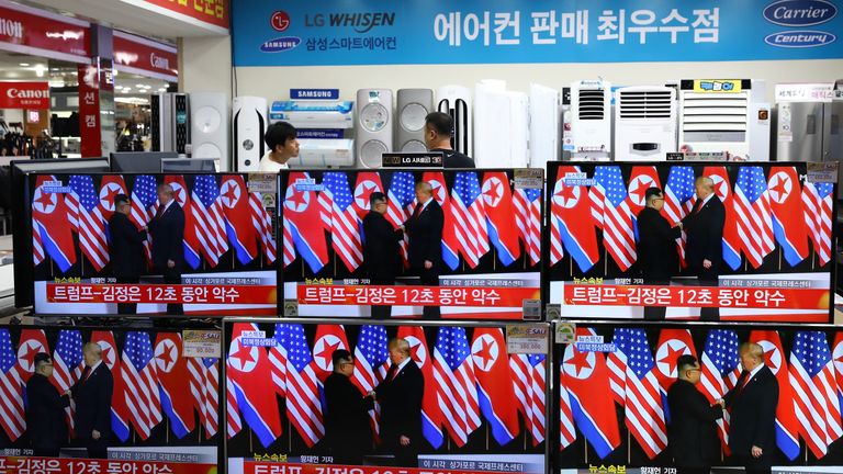 Donald Trump and Kim Jong Un&#39;s historic meeting as seen on TV screens at a retail store in Seoul