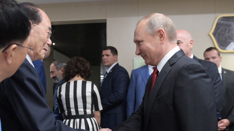 Vladimir Putin (R) shakes hands with President of the North Korean Presidium of the Supreme People's Assembly Kim Yong-nam