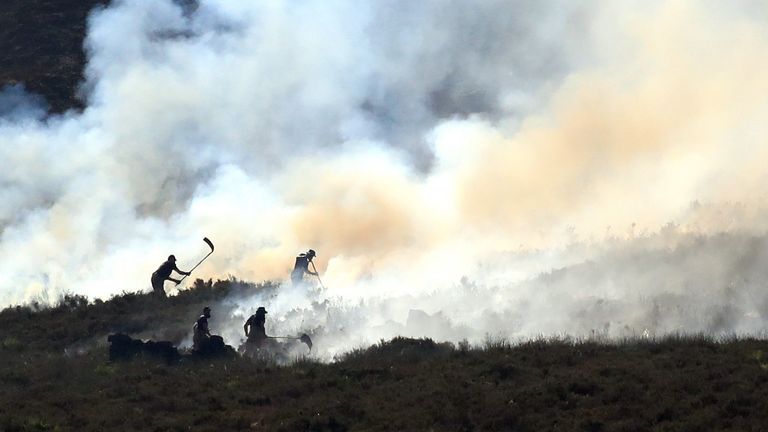 Firefighters tackle the wildfire as it continues to spread