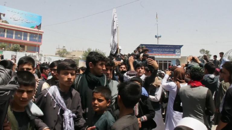 Locals in Kunduz take pictures with Taliban fighters