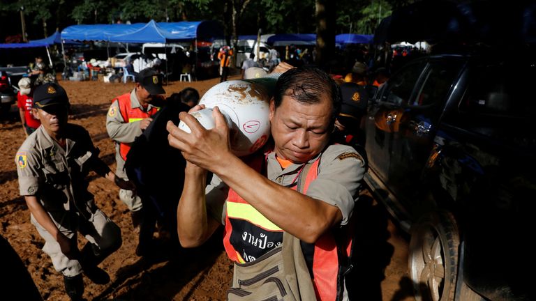 Rescue workers work near Tham Luang cave complex