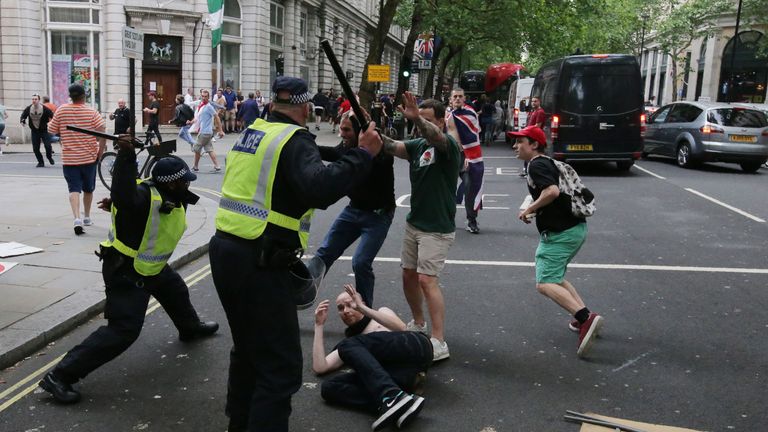 Protesters scuffle with police at the junction of Whitehall and The Mall after a gathering by supporters of far-right spokesman Tommy Robinson turns to violent, in central London on June 9, 2018. (Photo by Daniel LEAL-OLIVAS / AFP) (Photo credit should read DANIEL LEAL-OLIVAS/AFP/Getty Images)
