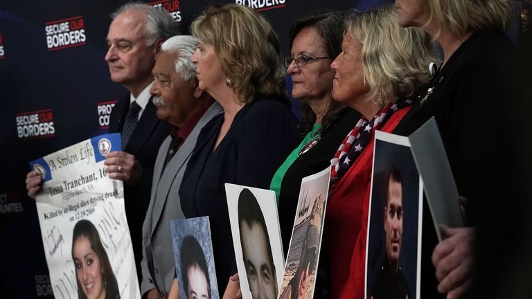 Family members hold portraits of their deceased loved ones that were signed by President Donald Trump during an event with 'Angel Families' June 22, 2018