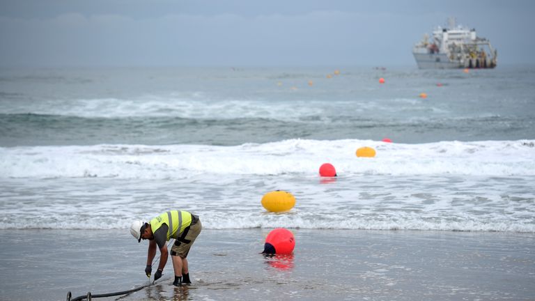 An operator works during the mooring of an undersea fiber optic cable at Arrietara beach near the Spanish Basque village of Sopelana on June 13, 2017. Facebook and Microsoft have paired up to run a giant underwater cable dubbed Marea (tide) that will stretch from Virginia in the US to Bilbao, Spain, crossing some 6,600 kilometers of ocean. / AFP PHOTO / ANDER GILLENEA (Photo credit should read ANDER GILLENEA/AFP/Getty Images)
