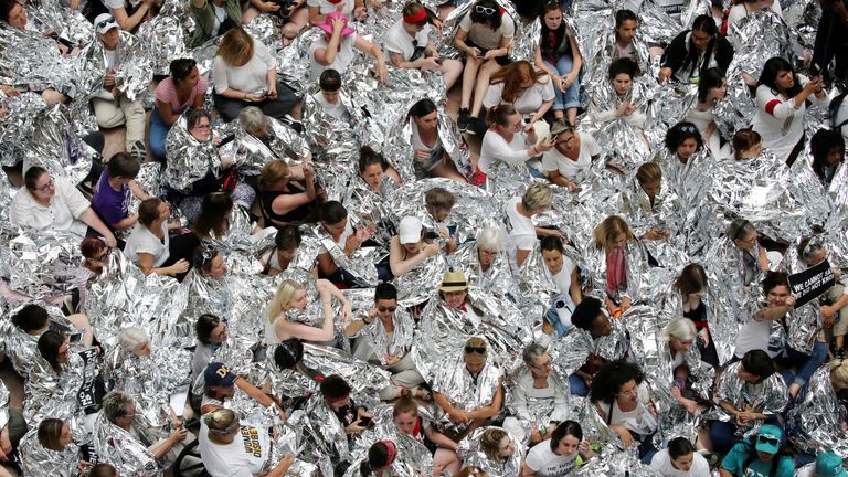 Immigration activists wrapped in silver blankets, symbolising immigrant children that were seen in similar blankets at a U.S.-Mexico border detention facility in Texas, protest inside the Hart Senate Office Building after marching to Capitol Hill in Washington, U.S., June 28, 2018. REUTERS/Jonathan Ernst