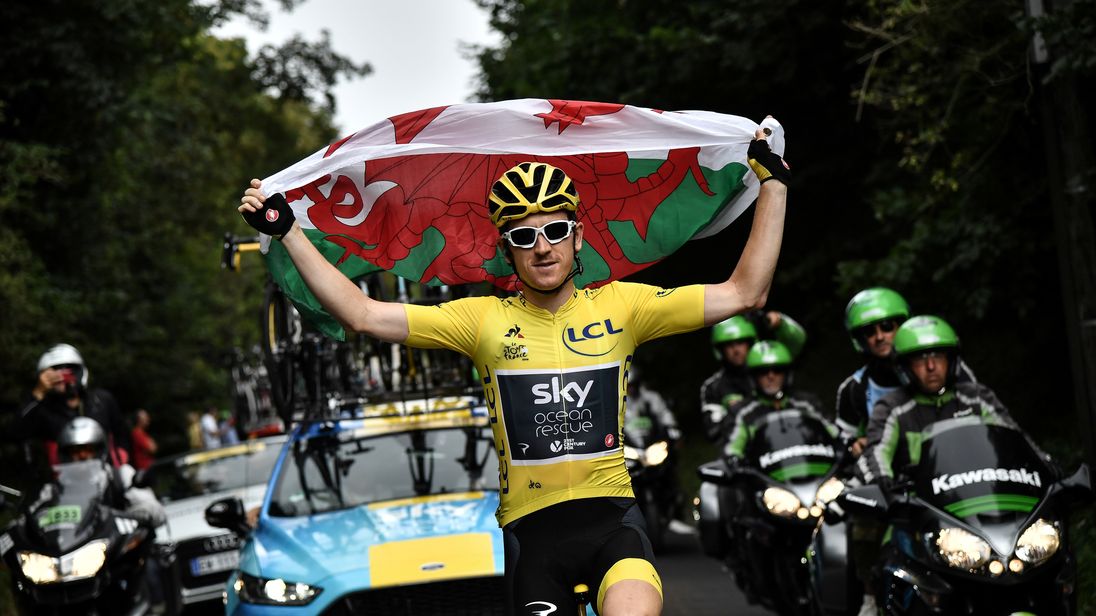 Great Britain's Geraint Thomas holds the Welsh flag
