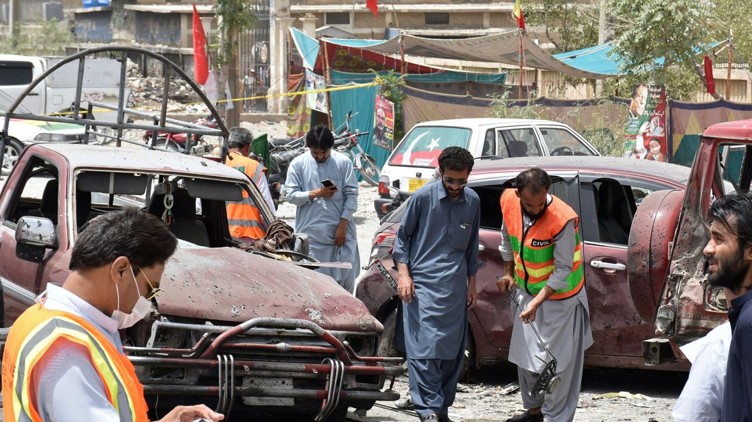 Members of the bomb disposal unit survey the site after a suicide blast, in Quetta
