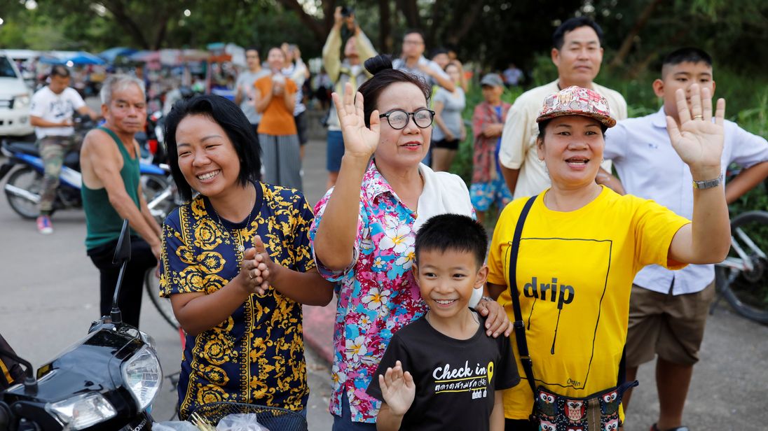 Onlookers wave as an ambulance carrying rescued schoolboys leaves a military airport in Chiang Rai, Thailand, July 10, 2018. REUTERS/Tyrone Siu