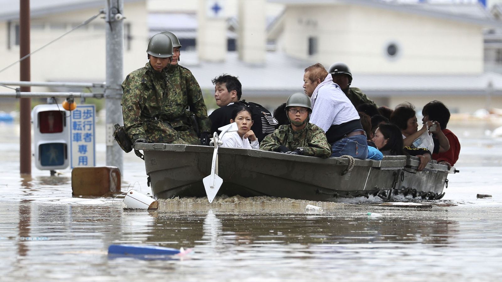 Japan's 'race against time' to save flood victims after dozens die