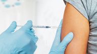 Nurse makes vaccination in the shoulder of patient in a clinic