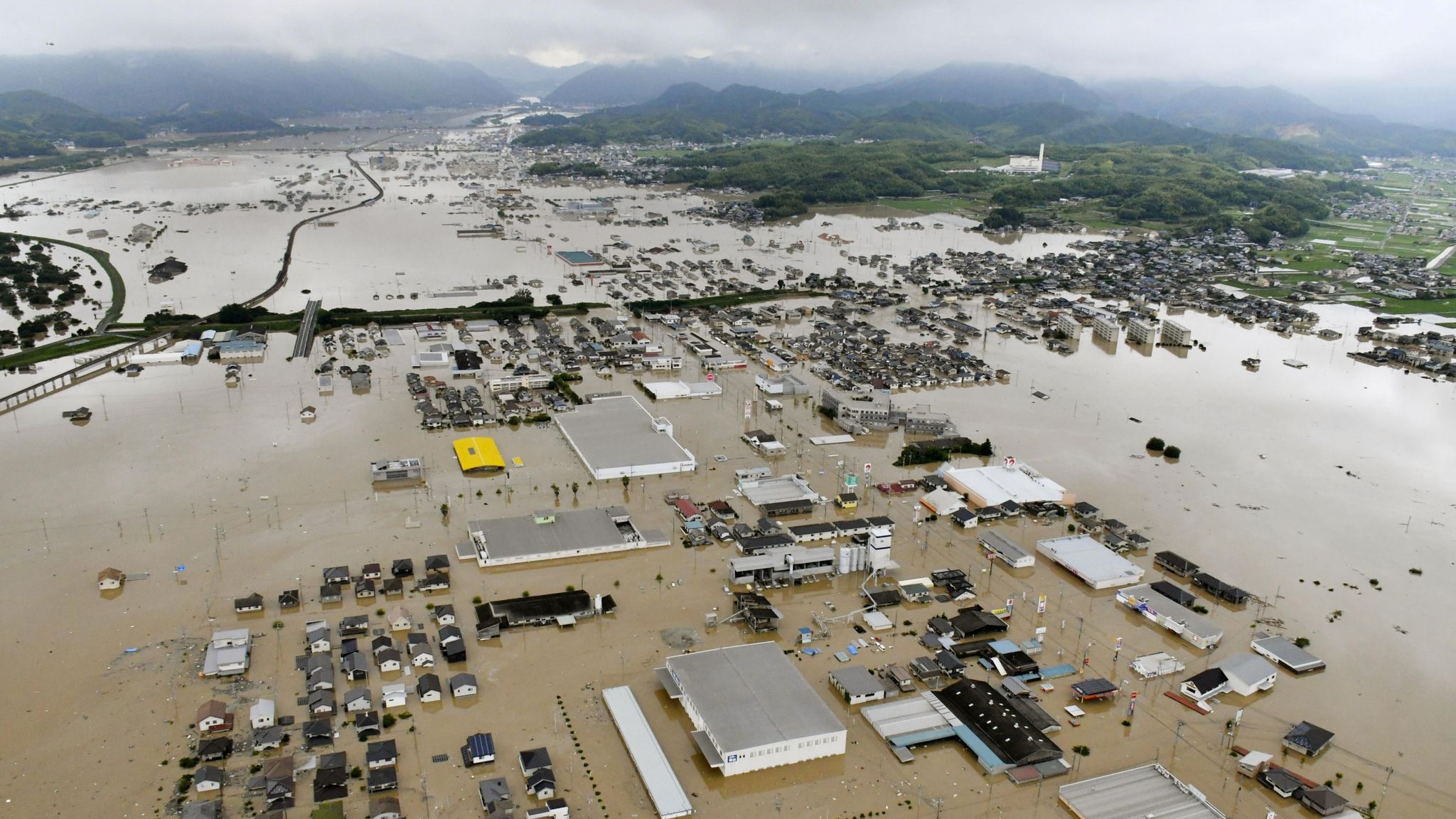 Japan's 'race against time' to save flood victims after dozens die