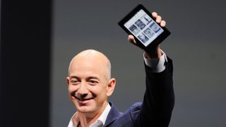 Amazon boss jeff Bezon with an Amazon Kindle