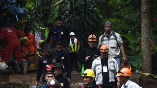 Thai rescue workers and technicians are seen at the Tham Luang cave area