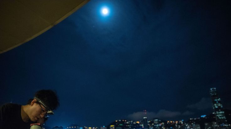   People are installing telescopes to observe the lunar eclipse at Tsim Sha Tsui in Hong Kong 