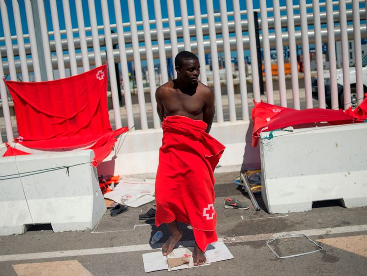 Glenn Alban, 18, from Cameroon who was rescued at sea stands at the harbour of Algeciras 
