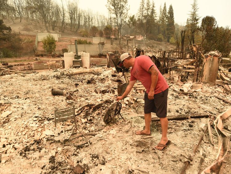 Wade Brilz looks at what remains of his burned home during the Carr fire in Redding