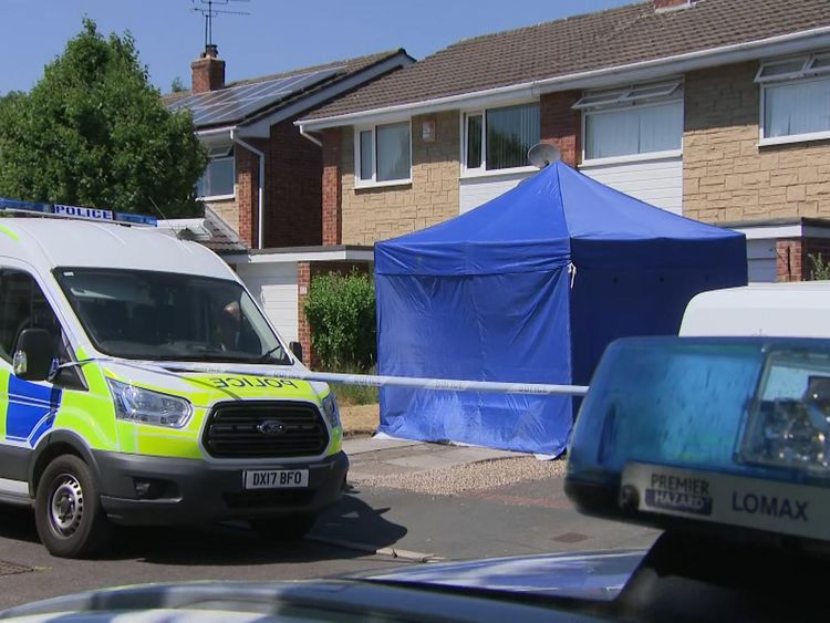 A forensics tent has been set up outside one home