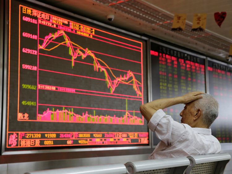 An investor reacts to stock market information in Beijing as the US tariffs come into effect