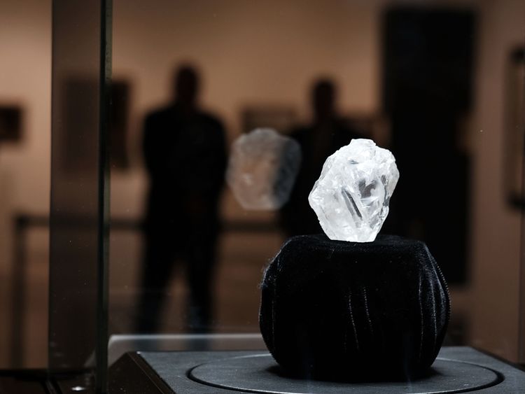   NEW YORK, NY - MAY 04: Guards the rough diamond Lesedi The Rona of 1109 carats, the largest rough diamond discovered in more than a century, at Sotheby's on May 04, 2016 in New York. The stone was found by Lucara Diamond Corp. last year at his Karowe mine in Botswana. The diamond, which is almost the size of a 66.4 x 55 x 42 mm tennis ball and is said to be between 2.5 billion and 3 billion years old, was named 