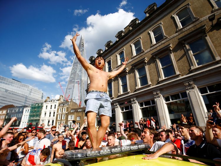 England fan celebrates on top of an ambulance after the match 