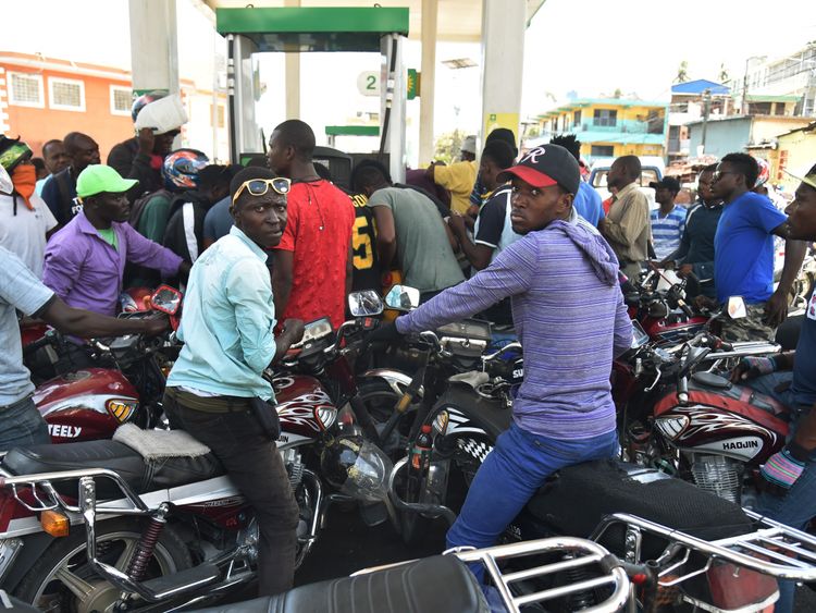 Haitian people wait to purchase fuel at a gas station in Petion Ville one of the few gas stations open during the strike to protest the hike in fuel prices