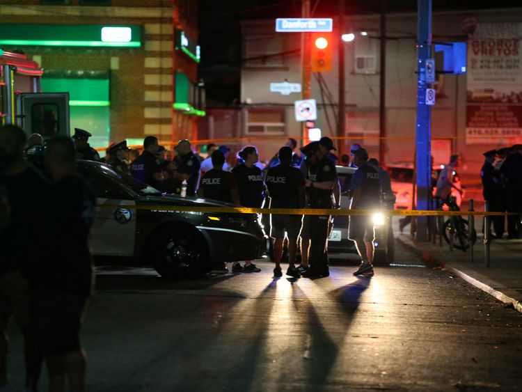 Police are seen near the scene of a mass shooting in Toronto, Canada, July 22, 2018