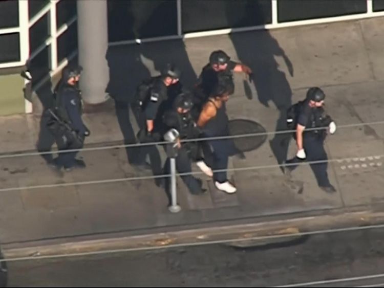 The suspect was led away in handcuffs after around three hours