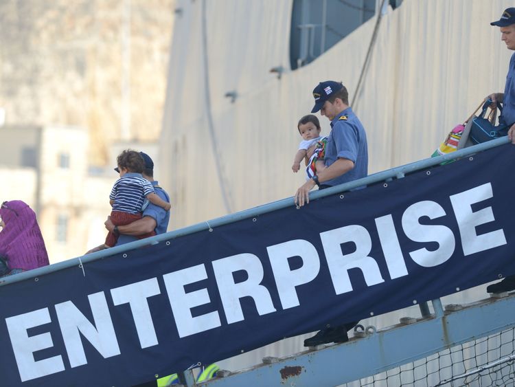 People disembark from HMS Enterprise in Malta following the 2014 Tripoli evacuation 