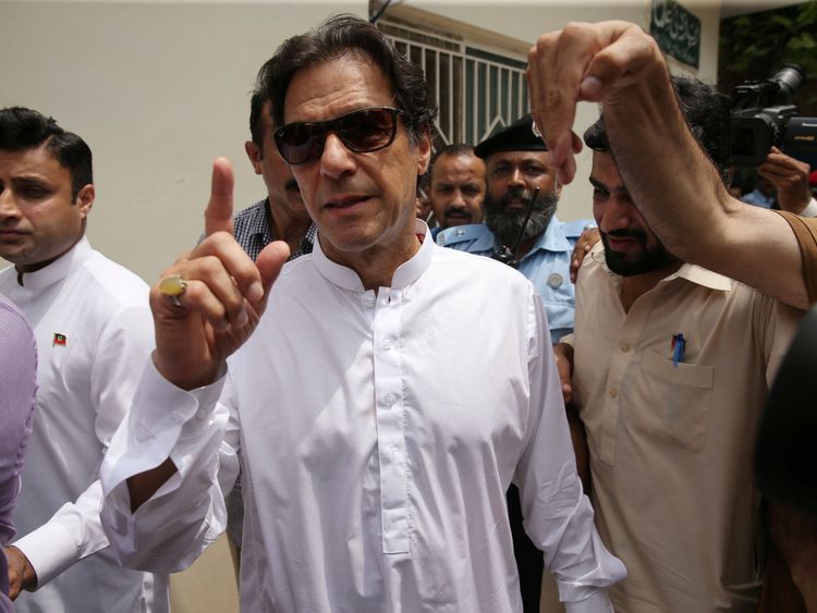 Imran Khan, chairman of Pakistan Tehreek-e-Insaf (PTI), arrives at a polling station during the general election in Islamabad