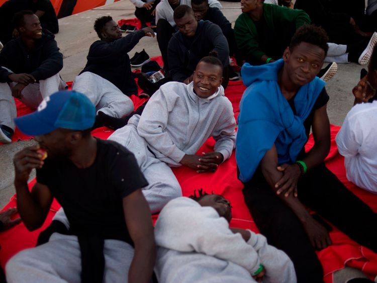 Migrants rescued at sea wait to be transferred at the harbour of Algeciras