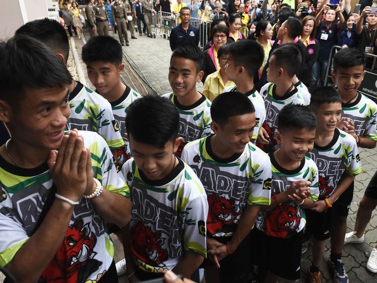 The 12 boys and their football coach Ekkapol Chantawong