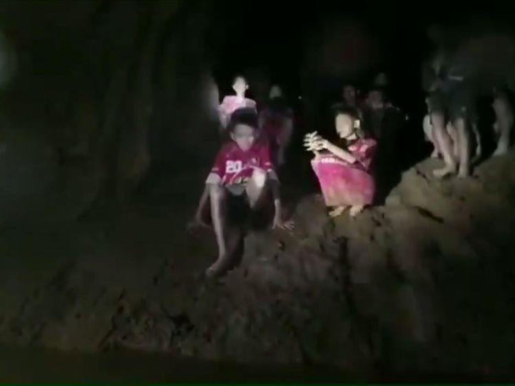 'We're coming' Moment British divers reach boys lost in Thai cave for