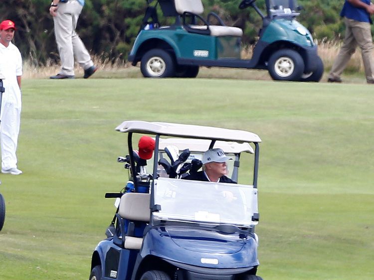 U.S. President Donald Trump drives his golf buggy at his golf resort, in Turnberry, Scotland  July 14, 2018.  REUTERS/Henry Nicholls - RC1F6D3EBA20