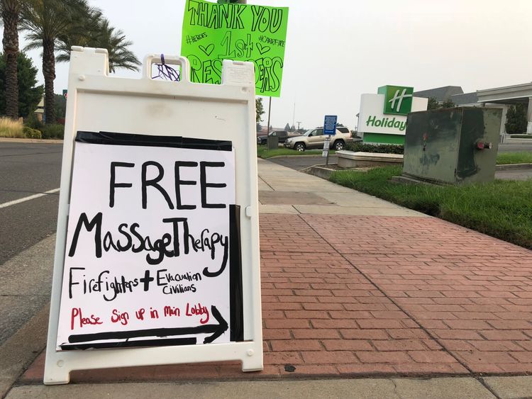 A resident of Redding offers free massage to firefighters