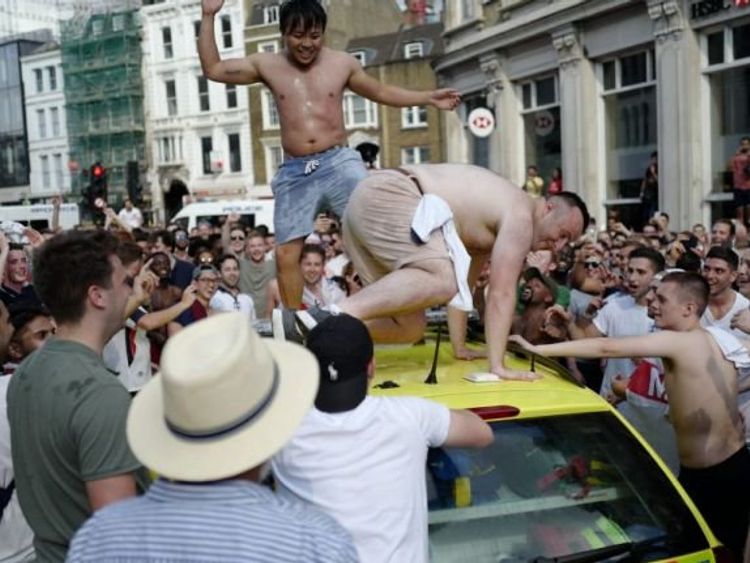 Two half-naked men were dancing on the roof