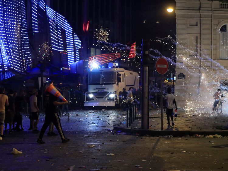 French CRS riot police advance during clashes on the Champs-Elysees after after France win the World Cup final. 