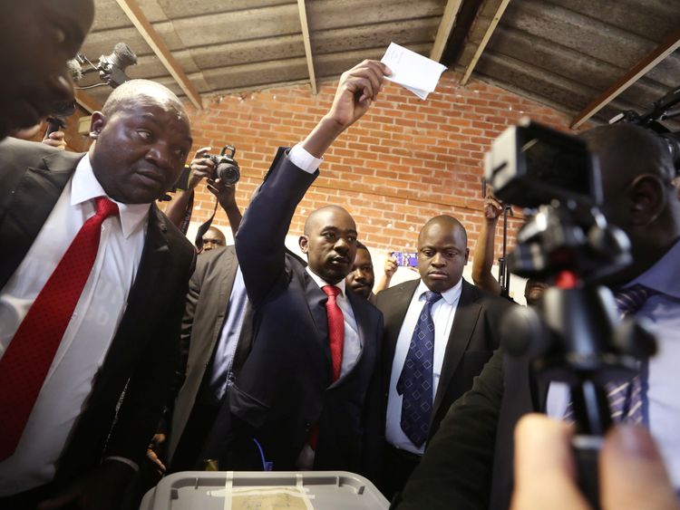 Nelson Chamisa held his ballot paper in the air as he voted in Harare