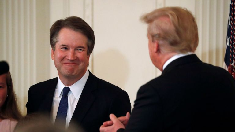 Supreme Court nominee Judge Brett Kavanaugh smiles next to U.S. President Donald Trump in the East Room of the White House in Washington