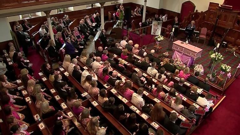 Many mourners dressed in pink