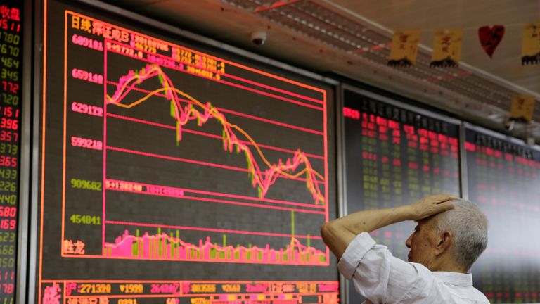 An investor reacts to stock market information in Beijing as the US tariffs come into effect
