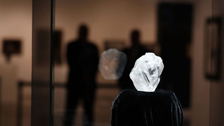 NEW YORK, NY - MAY 04: Guards stand next to the 1109-carat rough Lesedi La Rona diamond, the biggest rough diamond discovered in more than a century, at Sotheby's on May 04, 2016 in New York City. The stone was found by Lucara Diamond Corp. last year at its Karowe mine in Botswana. The diamond, which is nearly the size of a tennis ball at 66.4 x 55 x 42 mm and is believed to be about 2.5 billion to 3 billion years old, was named 'Our Light' in the local Tswana language. Lesedi La Rona will be of