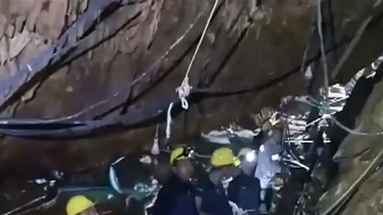 Rescue workers attempt to make a path to the stranded boys in Thailand caves