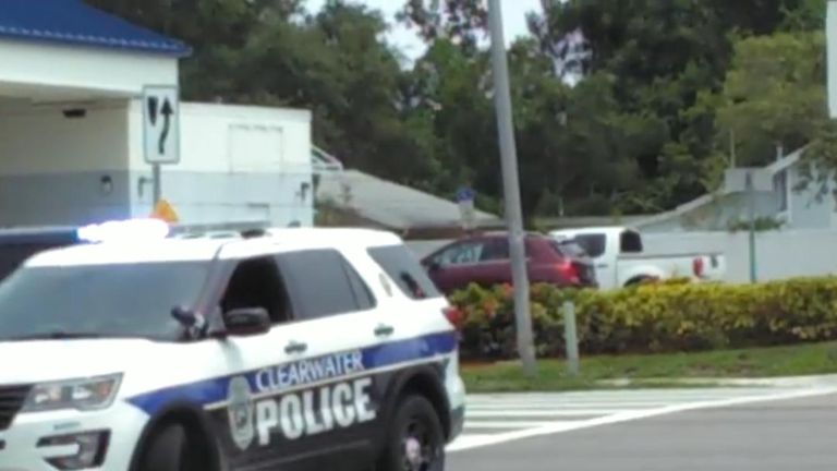Duck family cross the street with police protection in Florida