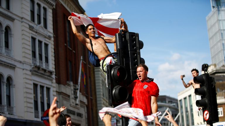 England fans watch Sweden vs England - London, Britain - July 7, 2018 England fans celebrate by climbing traffic lights after the match REUTERS/Henry Nicholls